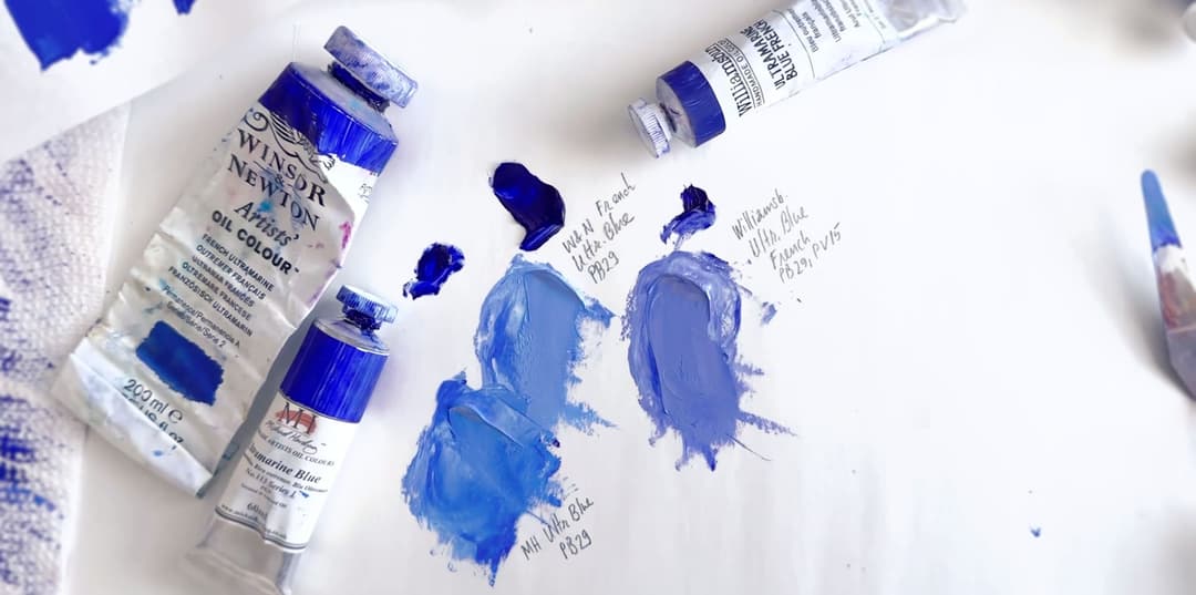 Three tubes of oil paint, and three areas of mixes with white. Two are more blue and one is more blue-purple.