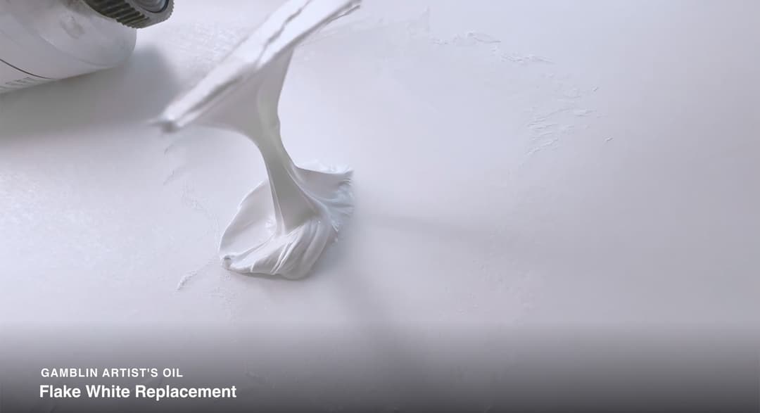 A palette knife draws up the Flake White Replacement Paint to show that it actually pulls up into a rope instead of breaking off into a stiff peak like many of their other colors would. The palette knife demonstrates a ropey, elastic propensity of the paint