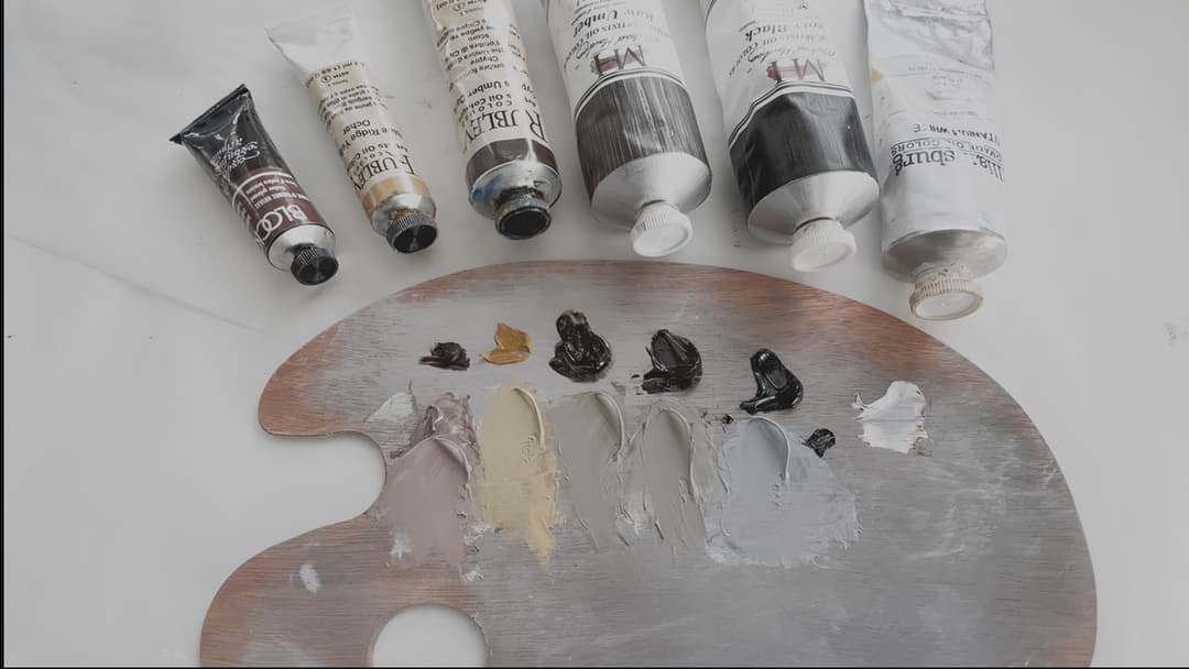 Six oil paints shown with a palette. The colors are tinted with white. None of the tints make a neutral grey by themselves- instead a mixture of 3-4 colors is usually needed.
