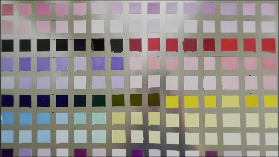 A panel with many squares of paints prepared for lightfastness testing