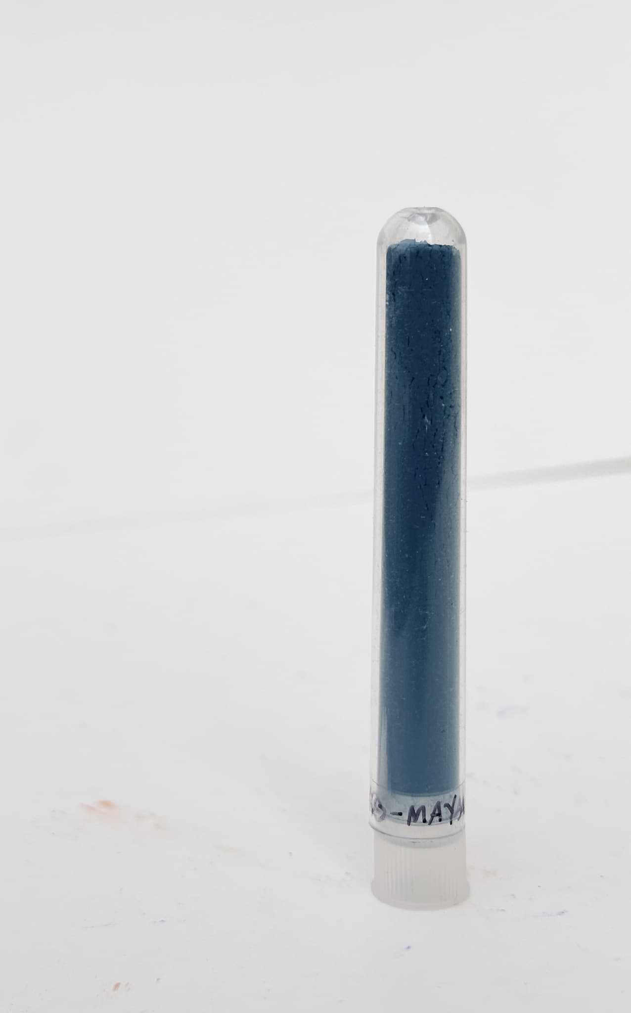 A tube filled with Maya Blue dry pigment