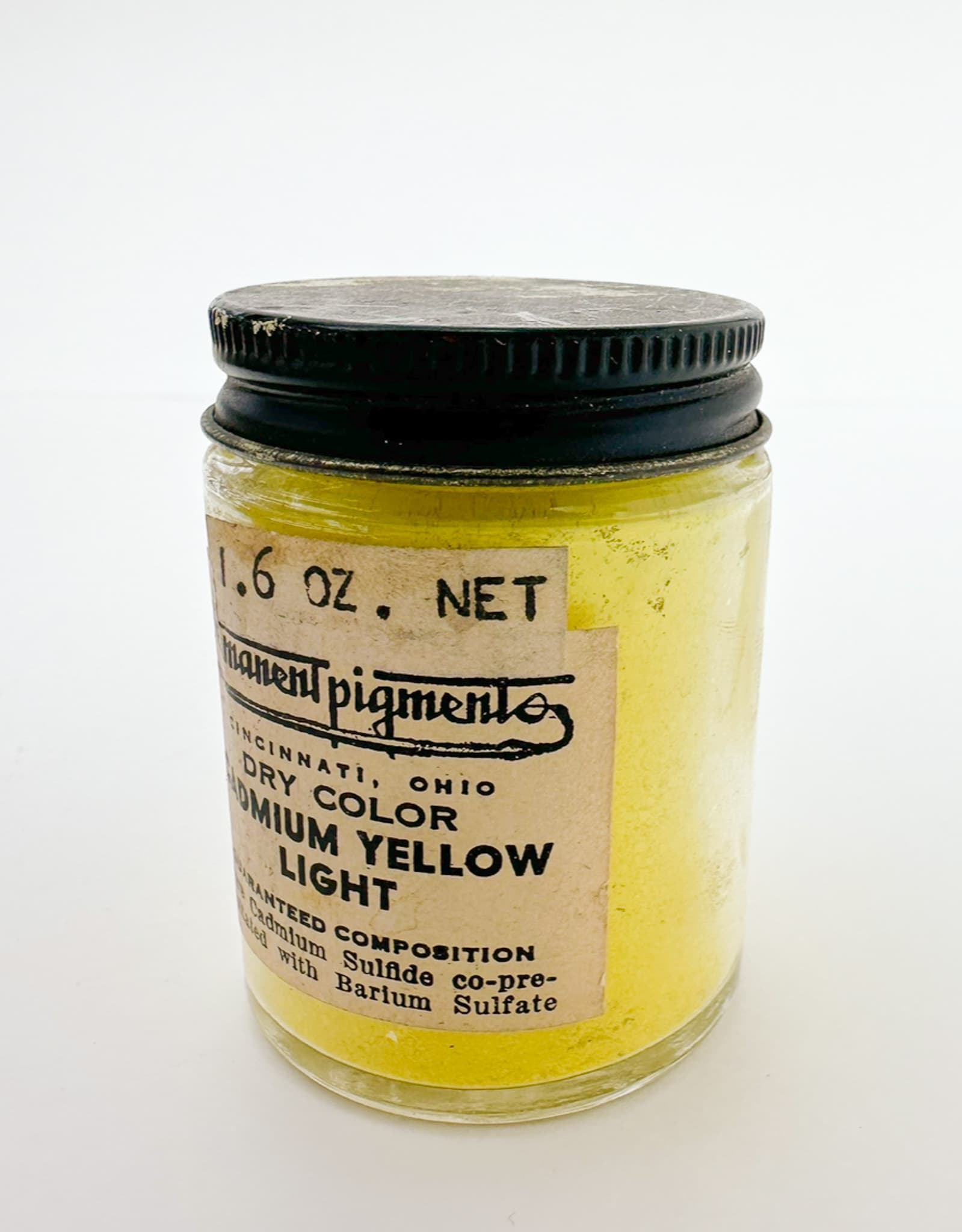 A jar of cadmium yellow dry pigment, PY35