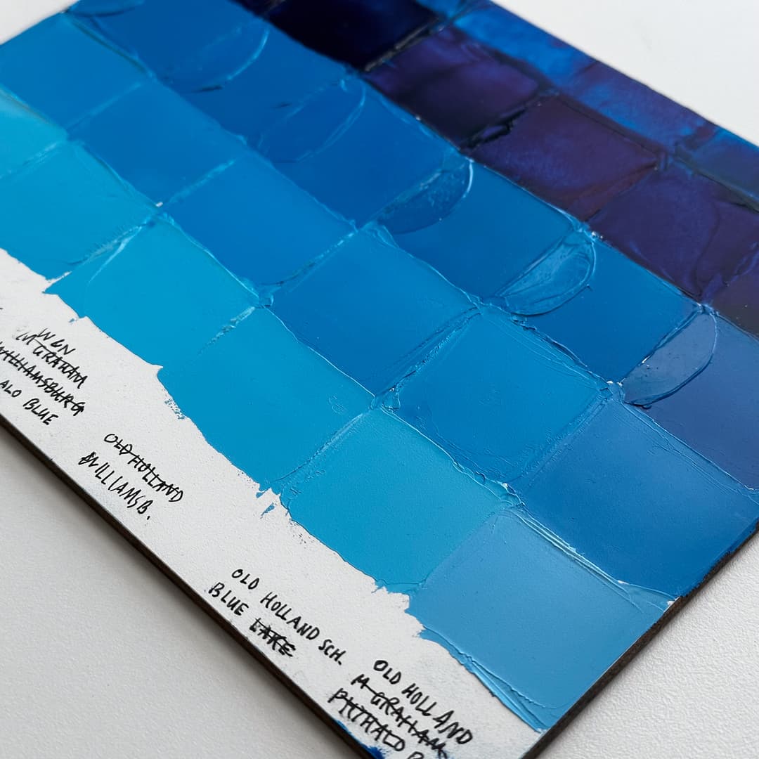 A painted panel showing swatches of phthalo blue mixed with white.
