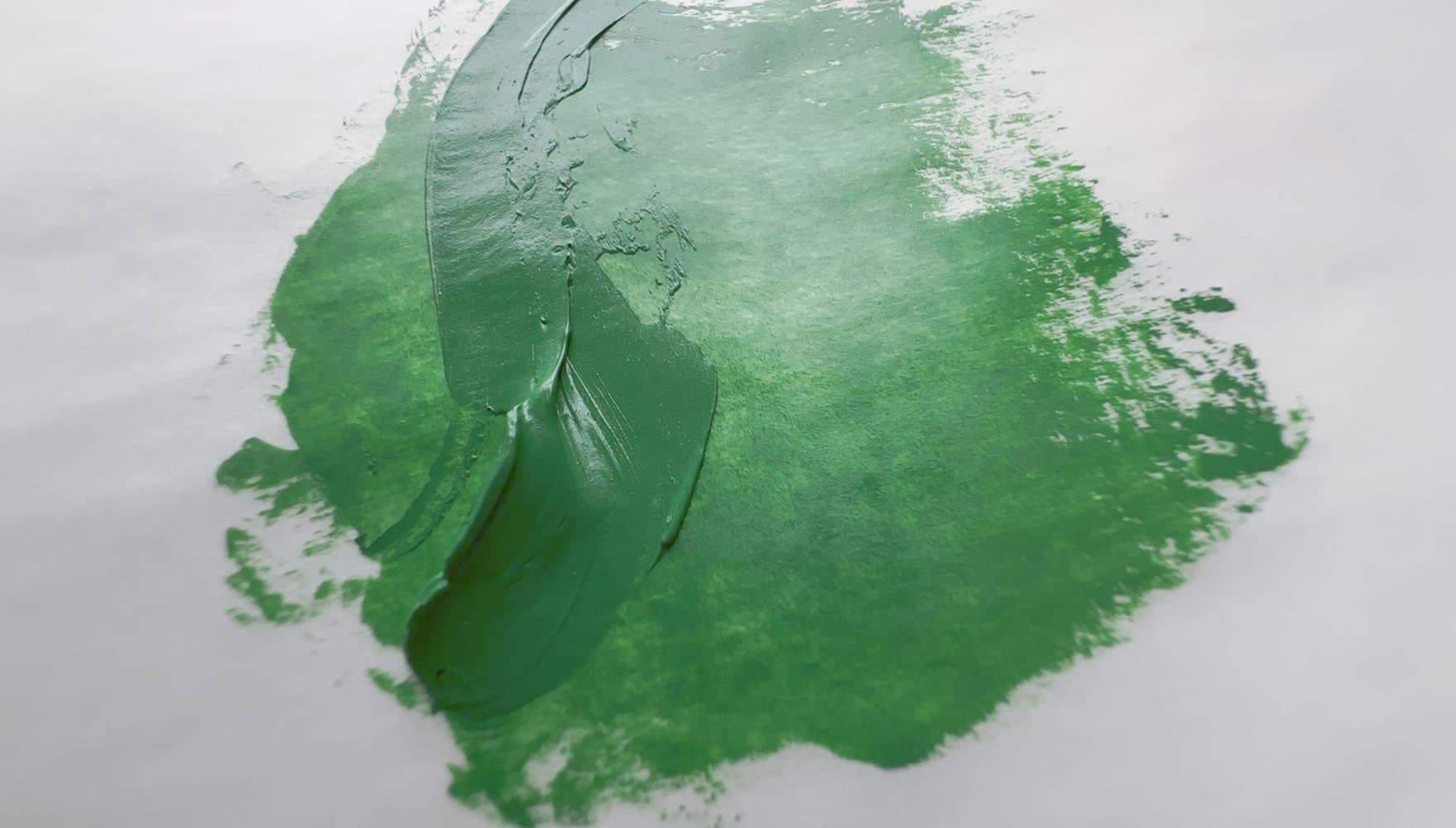 An impasto application of green oil paint made with PG19