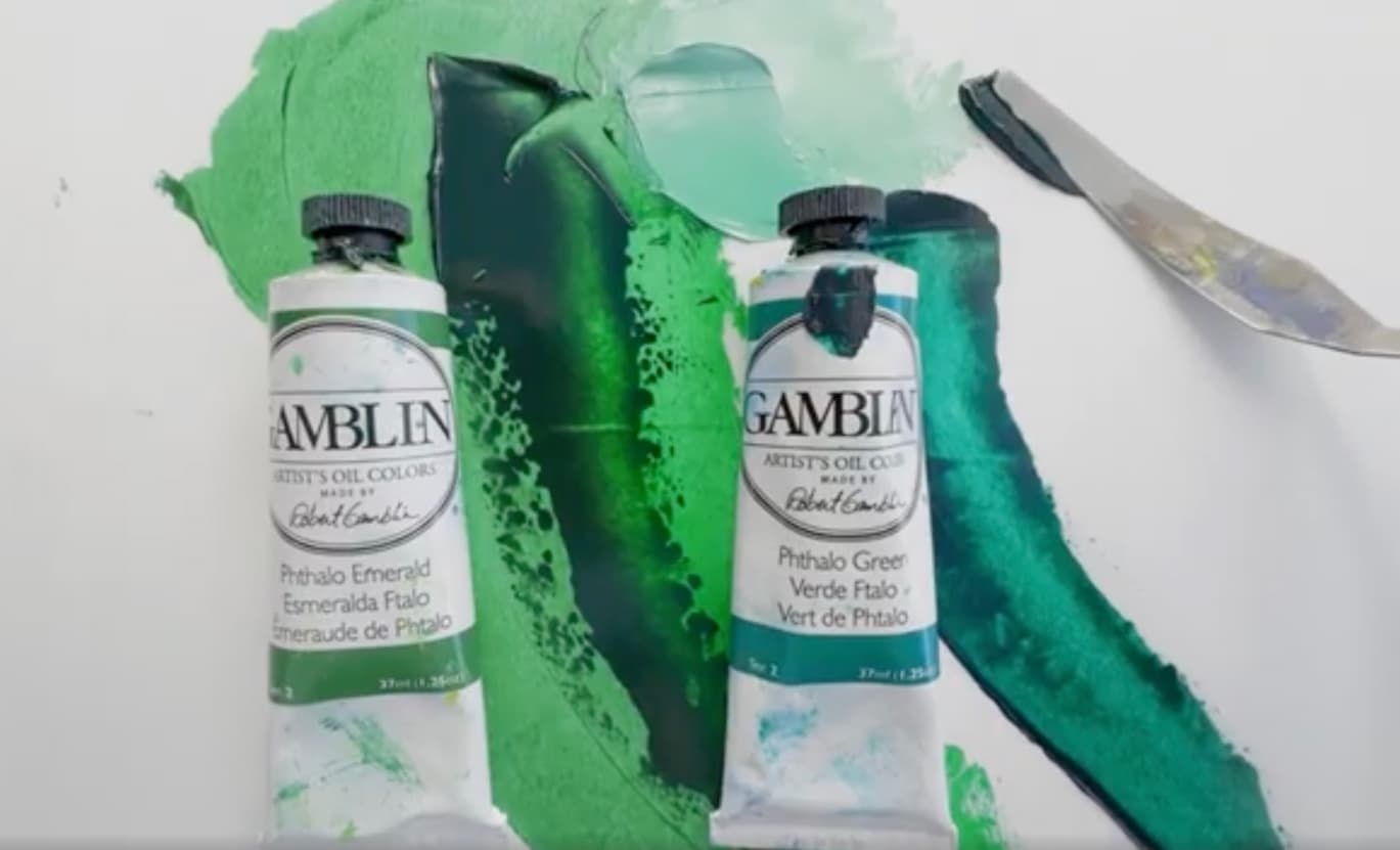Two tubes with swatches of oil paint. While both are green, Phthalo Green Yellow shade is a bit yellower while Phthalo Green Blue Shade is slightly bluer green.