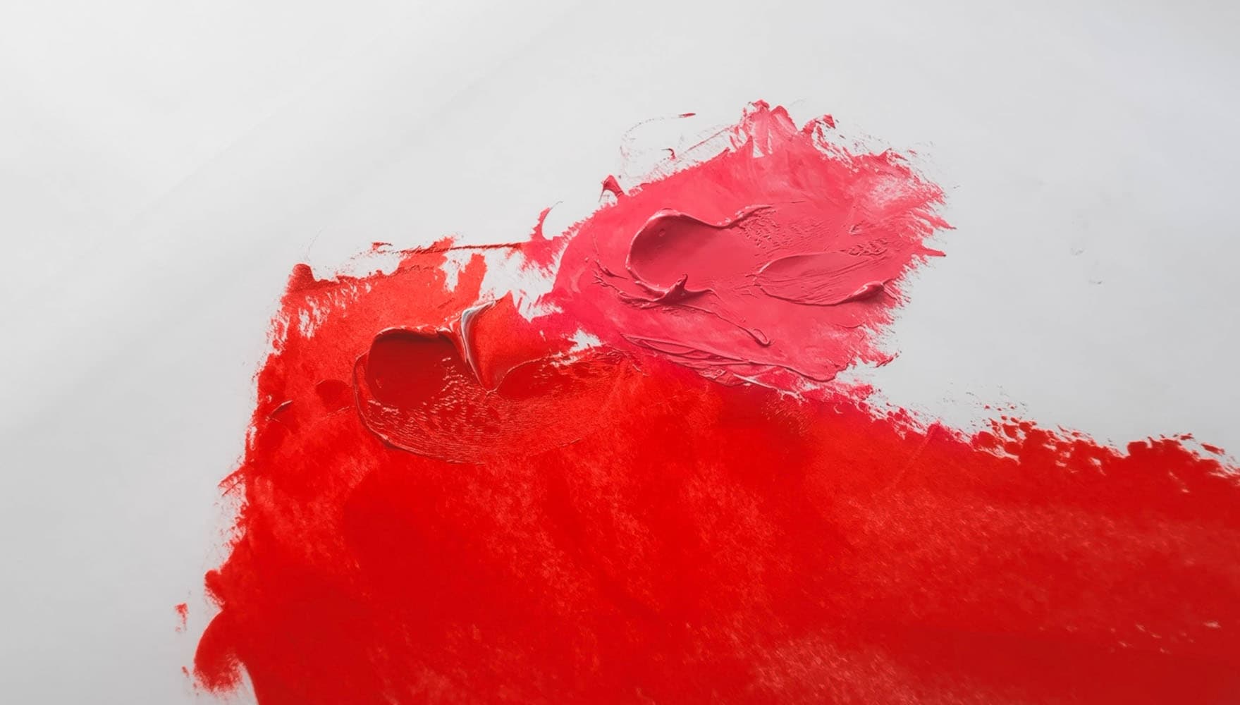 Red oil paint alongside a pink tint made with white