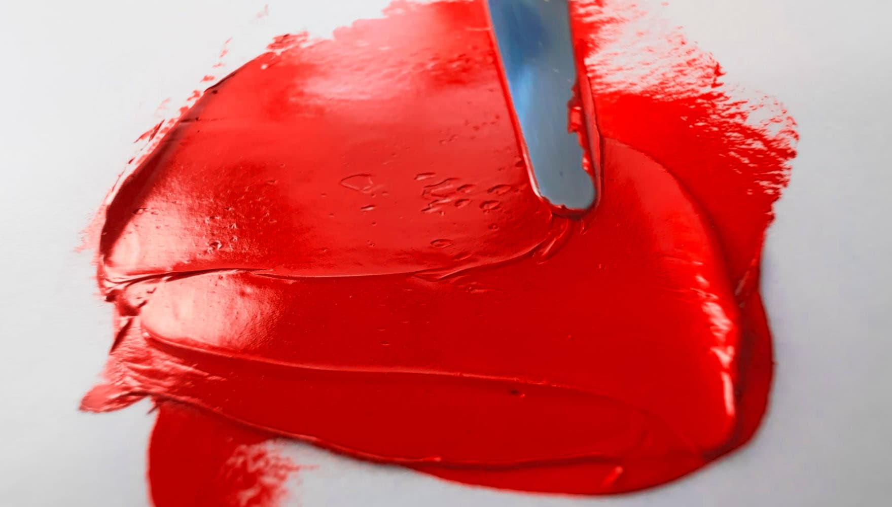 A swoosh of bright red oil paint