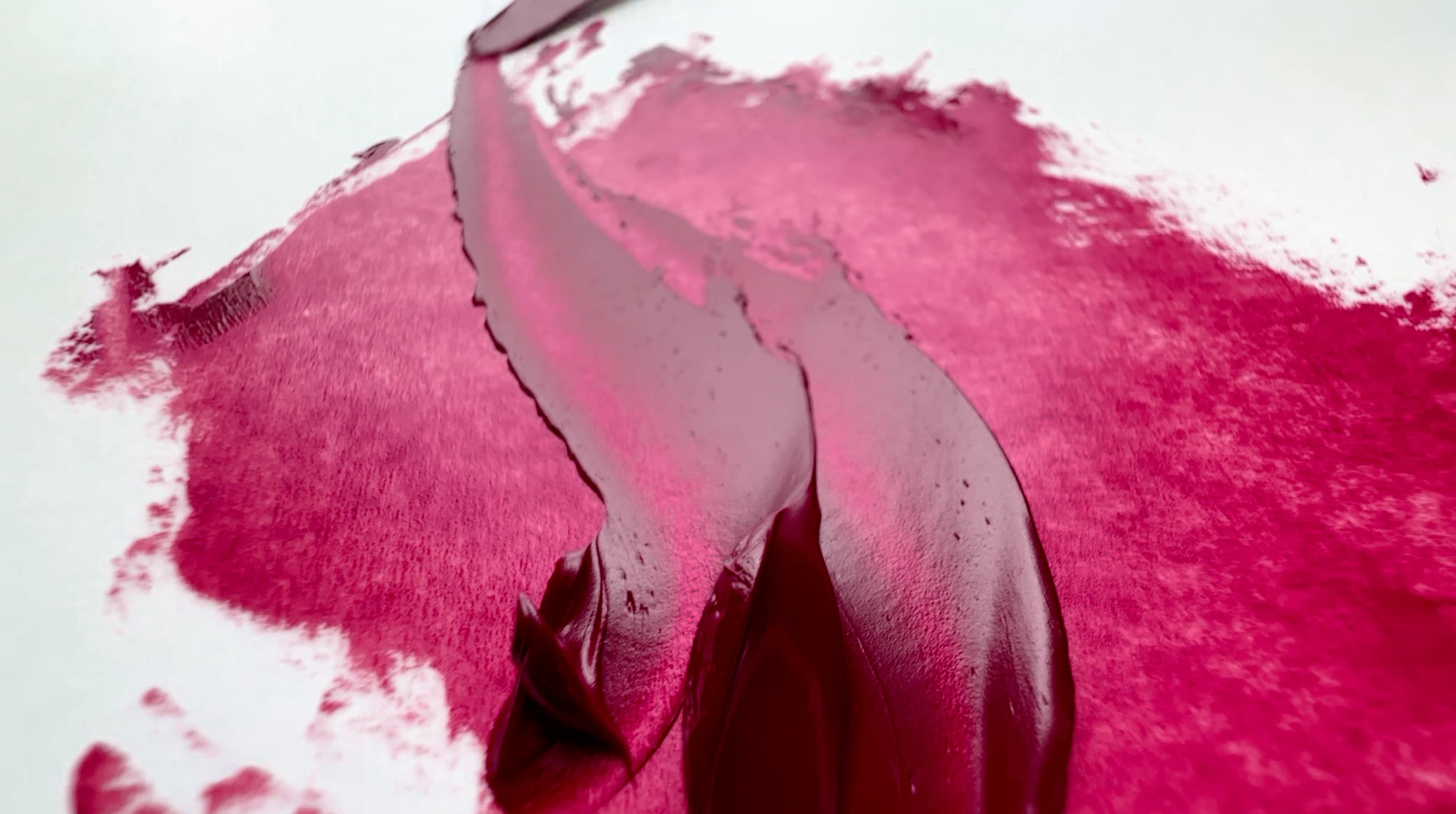 Two palette-knife strokes of magenta oil paint from Old Holland