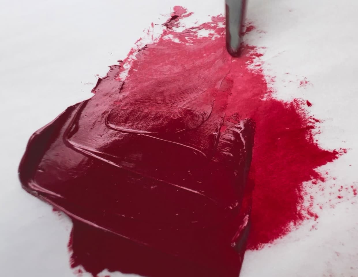 A swoosh of red oil paint