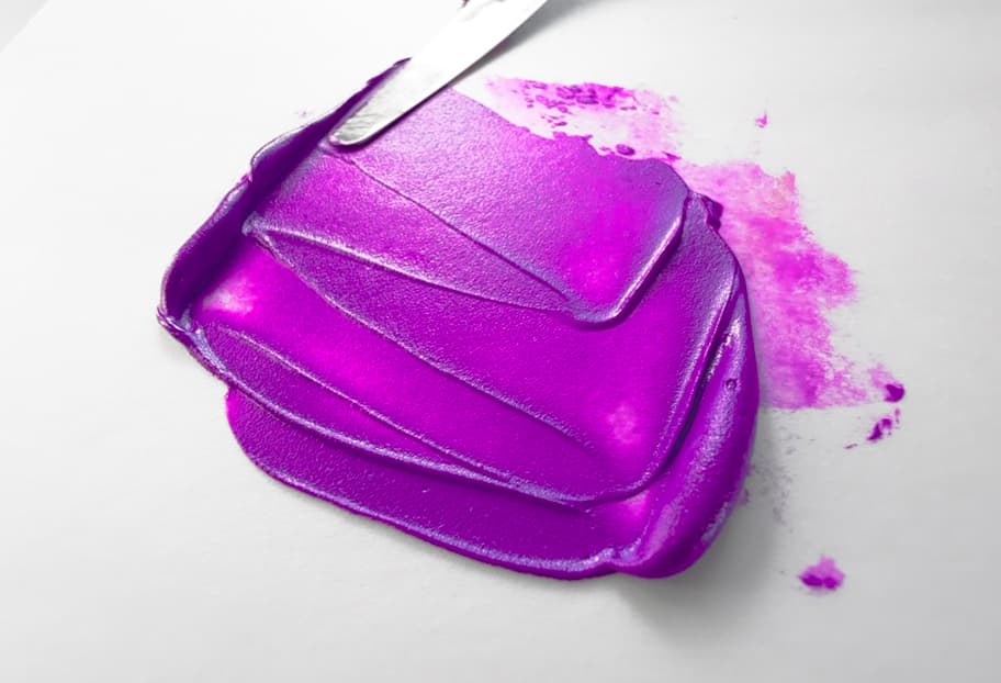 Impasto troughs of electric violet oil paint