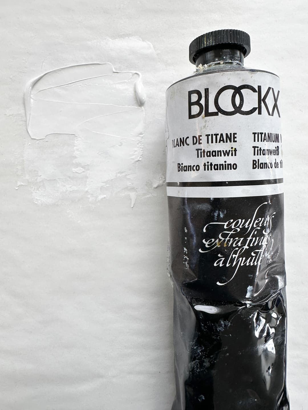 A tube of Blockx Titanium White bound in Poppy Oil with a swatch of paint.
