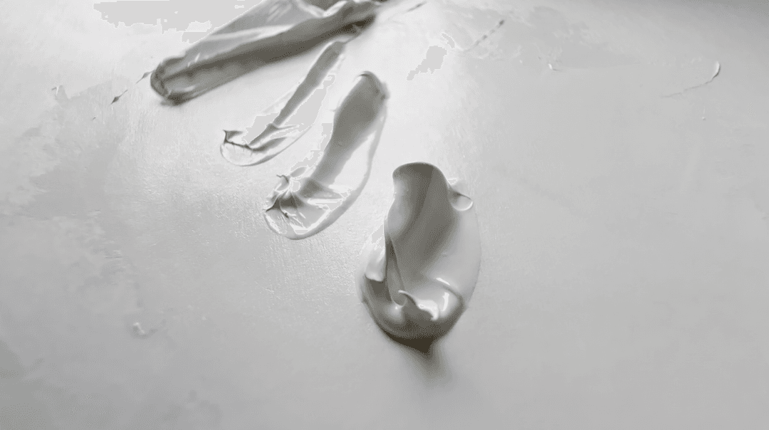 Three blobs of paint which have been pulled up by a palette knife. The paint has a bit of a wobble to it and forms falling peaks.