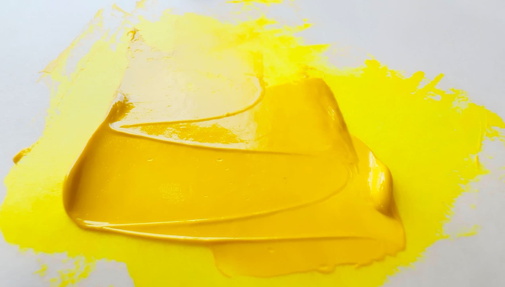 A swoosh of bright yellow transparent oil paint