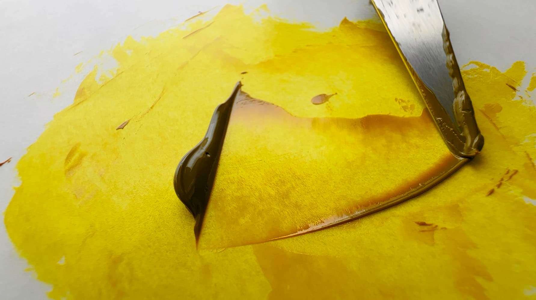 A stroke with a palette knife showing just how thinly transparent yellow may be spread