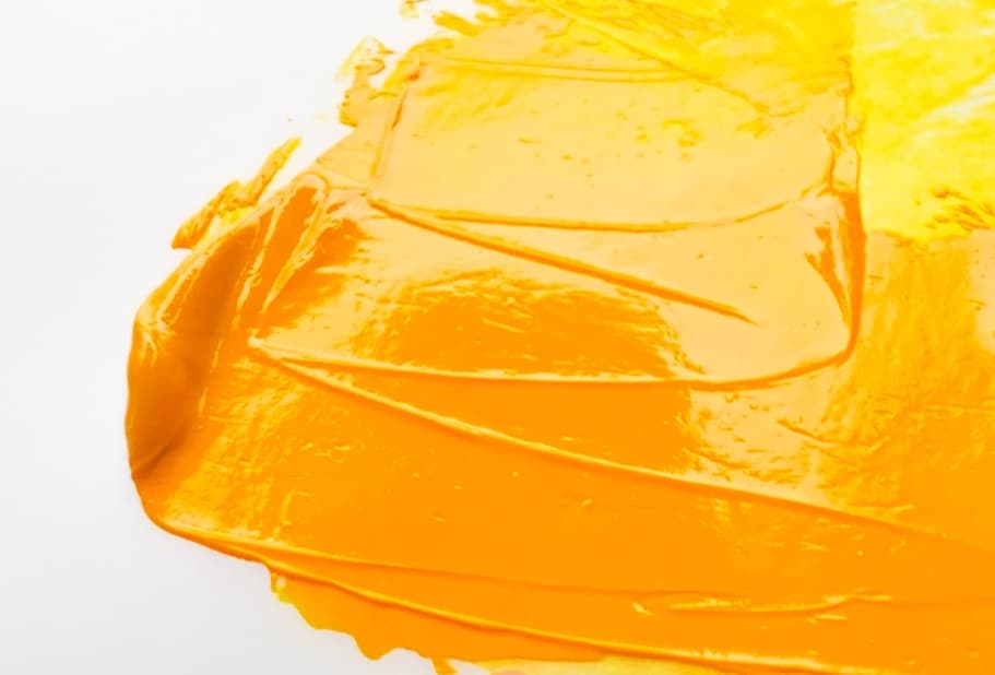 A swoosh of yellow-orange oil paint