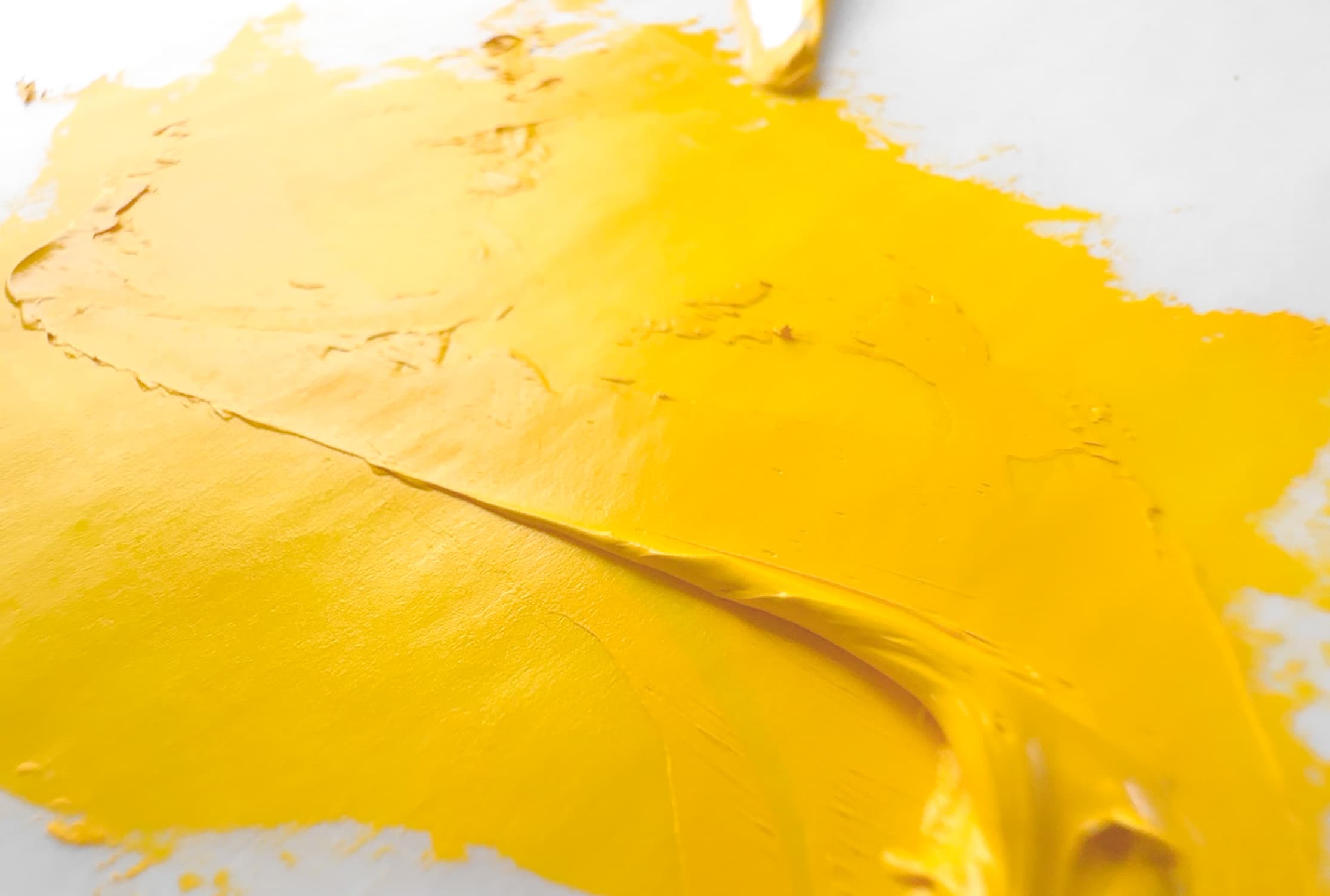 An impasto application of vintage chrome yellow oil paint