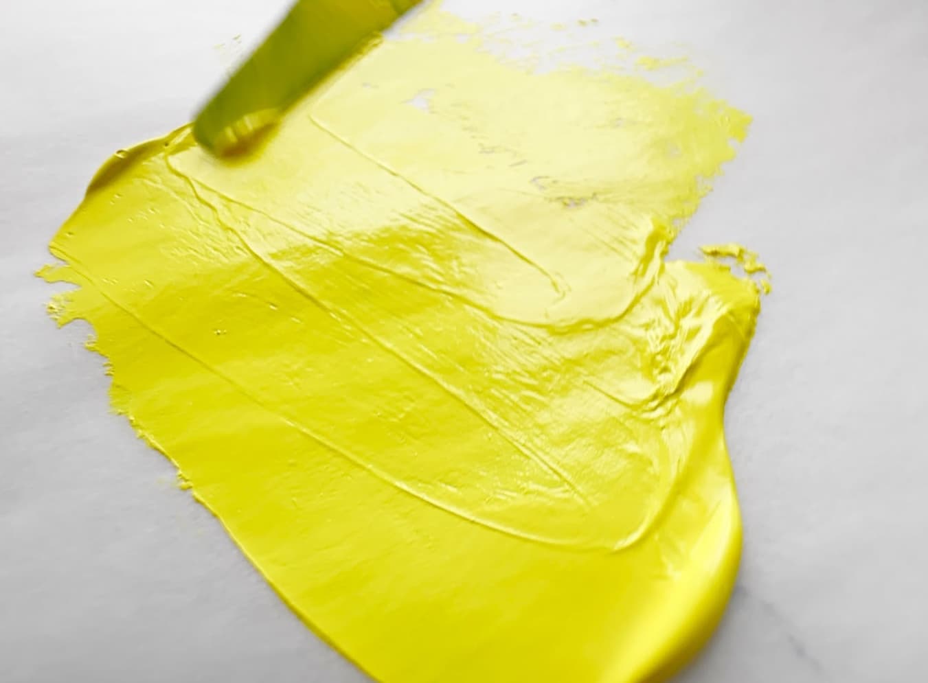 A swoosh of yellow oil paint made of cadmium yellow