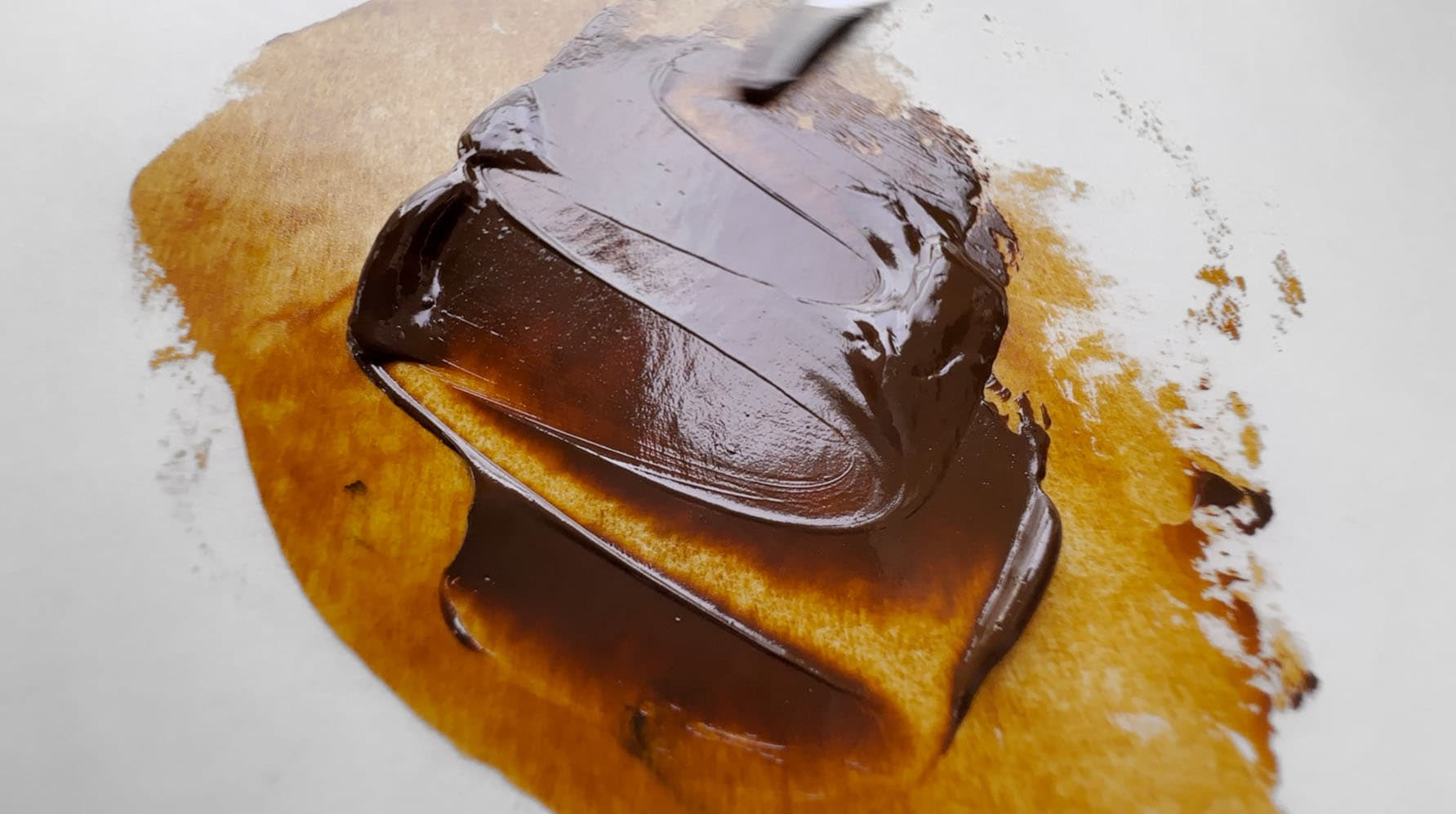 A swoosh of transparent brown oil paint