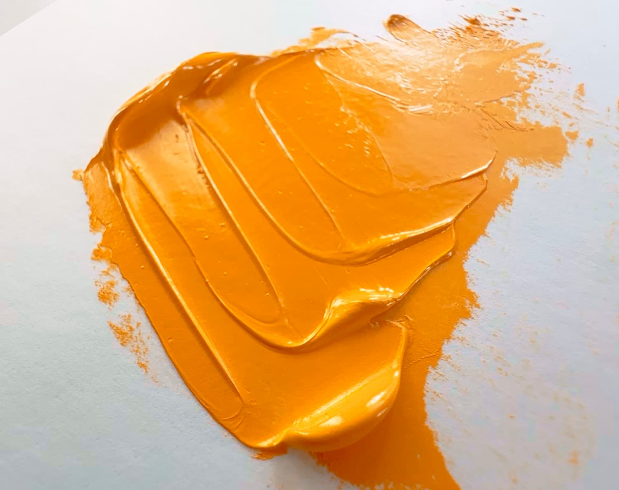 A bright, yellow-orange daub of Hansa Yellow, PY65, in oil paint